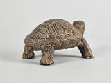 an old bronze figurine of a turtle on a white background