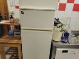 a refrigerator and a dishwasher in a small kitchen