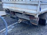 an image of a truck with a hose attached to the back of it