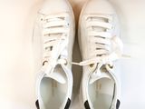 they are two pairs of white tennis shoes on a white surface