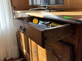 a tv that is sitting on top of a wooden cabinet