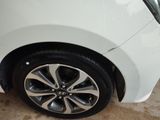 a close up of a white car with a black rim