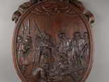 a wooden plaque depicting a scene in a medieval setting