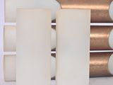 three white candles sitting next to each other on a table
