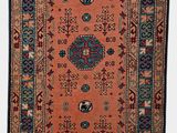 an orange and blue rug with a medallion design on it