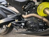 a close up of a motorcycle with a yellow exhaust pipe