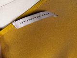 a close up of a person ' s hand holding a yellow purse