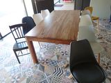 many chairs around a wooden table in a room