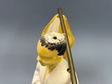 a figurine of a man with a umbrella on his head