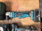 two electric tools that are sitting on a piece of paper