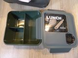 a lunch box with a knife, fork and spoon in it
