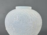 a white vase that is sitting on a table