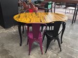 a table and chairs in a room with a wall in the background