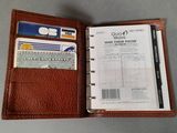leather wallet with credit cards and credit cards in it on a table