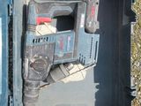 a cordless drill in a plastic case on the ground