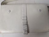 a white purse that is sitting on a table