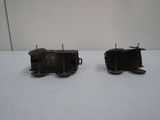 two small toy trains sitting on a white surface