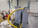 a picture of a machine in a warehouse with lots of wood