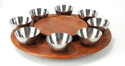 a wooden plate with six bowls on it on a white background