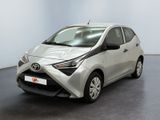 La Toyota AY est garée dans une pièce au sol noir.