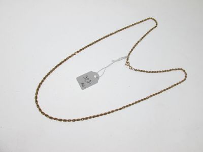 a close up of a gold chain with a tag on it