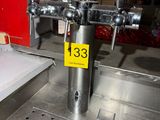 a stainless steel sink with a metal faucet on top of it