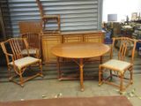 several chairs and a table in a room with a garage door in the background