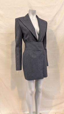 a mannequin dressed suit on a mannequin stand