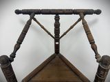 a wooden chair that has a wooden seat on top of it