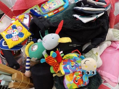 a pile of baby toys and toys on the floor