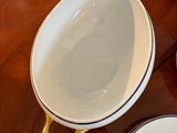 a wooden table topped with bowls and plates on top of it