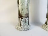 two vases that have been painted with a picture of a man and a woman