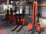 forklifts are parked in a warehouse in a large building
