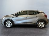 the silver car is parked in a room with a gray wall