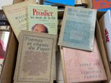 several books are in a cardboard box on top of a table