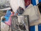 a pile of clothing and other items in a shopping cart
