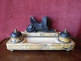 a statue of a bird sitting on top of a wooden table