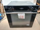 a black oven sitting on top of a cardboard box