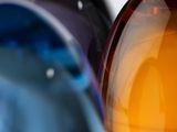 three different colored glass vases sitting on a table