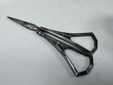 a pair of scissors sitting on a white surface