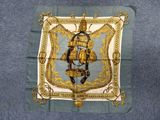 an image of a blue and gold scarf with a picture of a man on a horse