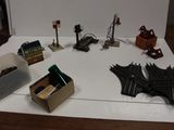 une table sur laquelle se trouvent plusieurs circuits de train miniature et une boîte sur laquelle est représentée une chauve-souris