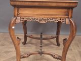 an old wooden table with a drawer on top of it on a hard wood floor
