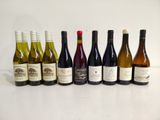 several bottles of wine are lined up in a row on a table