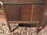 a small wooden table with a drawer on top of it