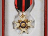 an image of a medal in a red box with a black and red ribbon