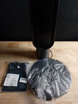 a black fan sitting on top of a wooden table