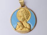 an image of a gold and blue pendant with an image of a child holding a cat