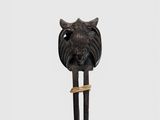 a close up of a sculpture of a lion head on a wooden pole