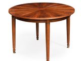 une table à manger ronde avec un plateau en bois et quatre pieds